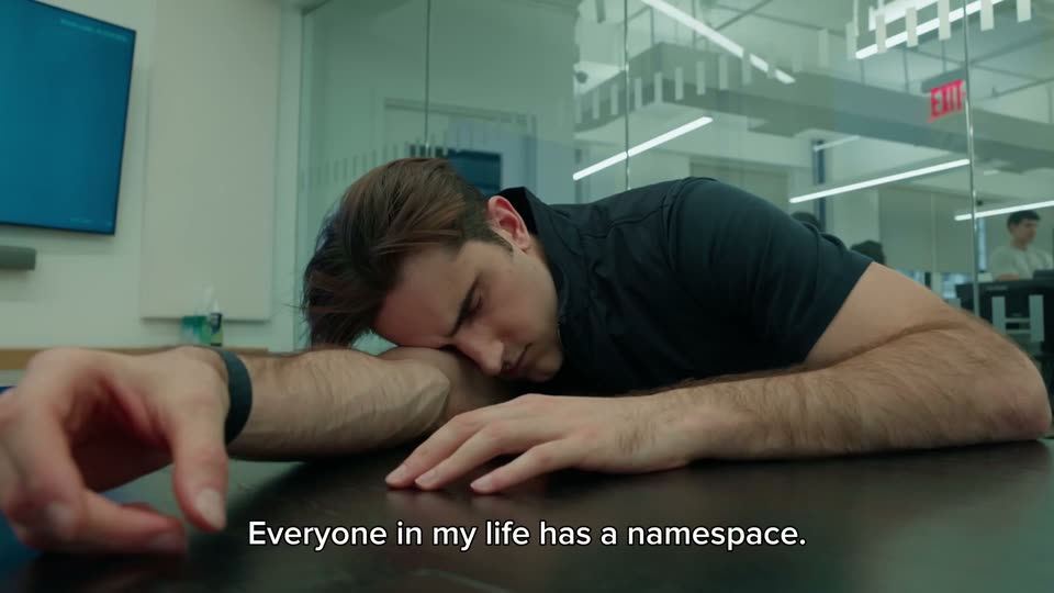 The cut: a man wakes face-down on a conference table. The description calls the engineer “the dream of every CEO”.