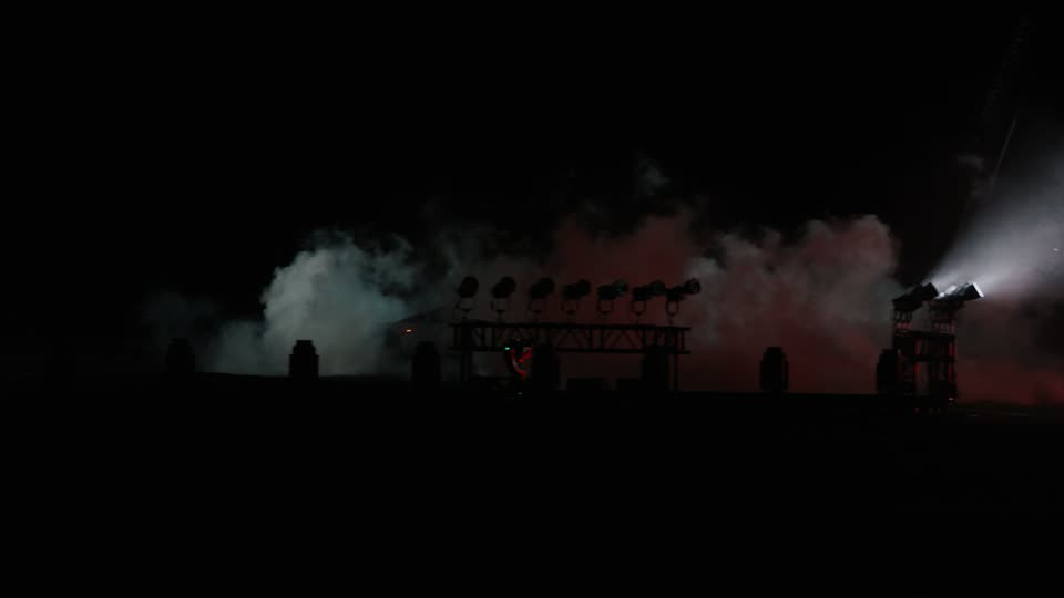 Floodlight trusses and smoke machines behind the landing area.